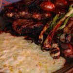 Plate of grilled meats and queso fundido in Tule