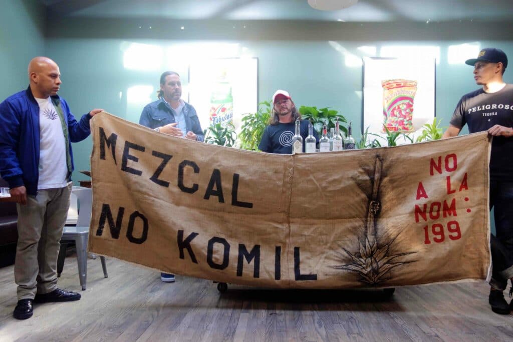 A protest banner against NOM 199 at the tasting. Photograph by Ferron Salniker